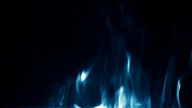 An isolated studio shot of dwindling blue flames on black background.