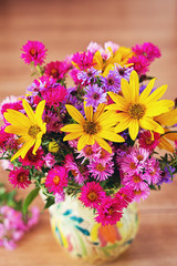 Obraz na płótnie Canvas Vase full og beautiful colorful flowers