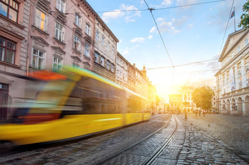 yellow tram rides on the morning  old european city.