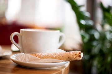 cup of coffee and cake on wooden table
