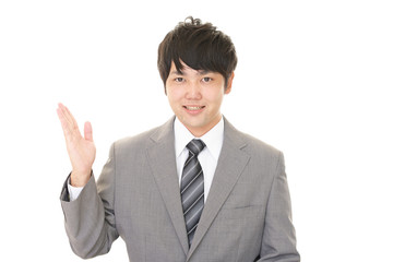 案内する笑顔のビジネスマン