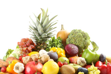 Ripe and tasty fruits and vegetables on a white background