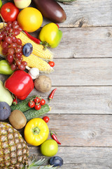 Ripe fruits and vegetables on wooden table