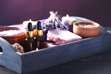 Lavender oil with soap, salt and flowers in blue tray