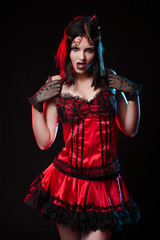 girl on a black background in witch dress