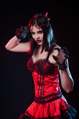 girl on a black background in witch dress