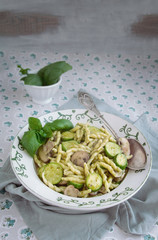 Typical genoa Pesto, Pasta Trofie with pesto, mushrooms and zucchini. Vegetarian dishes. Italian traditional cuisine food, recipes. 