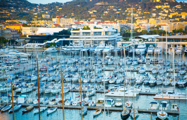 CANNES, FRANCE - 19 SEPTEMBER, 2016:   Old Port Vieux Port in the city of Cannes at sunset. Lots of sailing boats and power yachts anchored during the Sailing regatta. 
