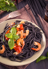 Black spaghetti with shrimps and basil