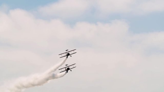 Slow motion view of acrobatic airplanes at an air show
