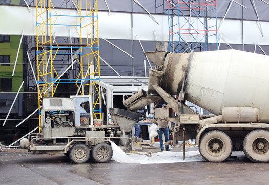 concrete pump and  mixer to work together  pouring cement floors in the shopping center for repair.