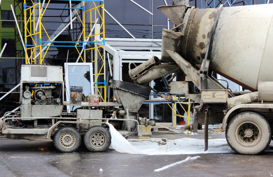 concrete pump and  mixer to work together  pouring cement floors in the shopping center for repair.