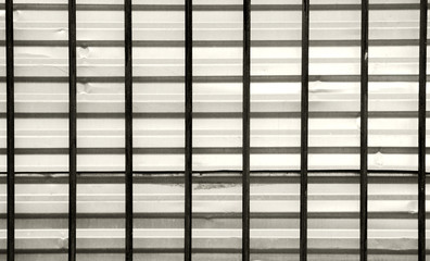 dark bars on a background of gray galvanized sheet, the intersection  the horizontal and vertical.