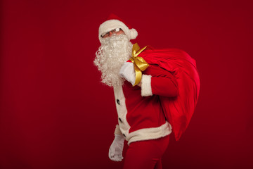 santa claus with big bag on shoulder glasses  red background
