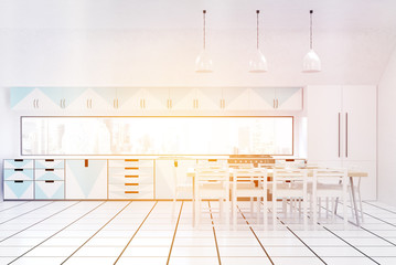 Front view of sunlit kitchen with green furniture