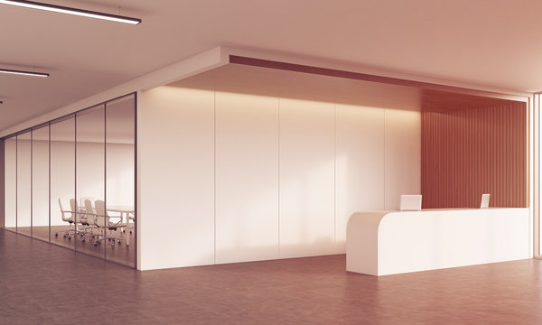 Reception desk and meeting room in sunlit corridor