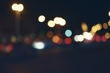 Retro toned blurred street and car lights, urban abstract night time background.