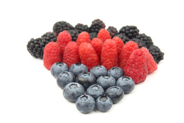 raspberries, blackberries and blueberries on white background