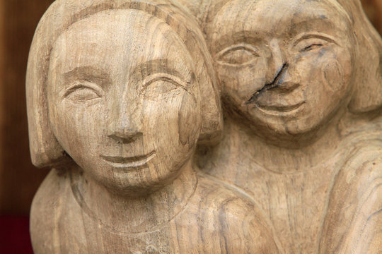 Sculpture d'un couple de personnages en bois.