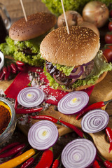 Fototapeta na wymiar Close-up of home made burgers, wooden desk background