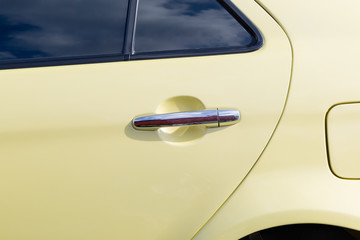 Silver handle on the door of retro car