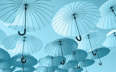  blue umbrellas under the beautiful cloudy sky. colorful summer