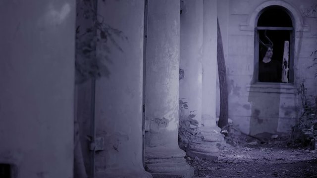 horned witch ghost walks through the ruins of the castle. halloween Horror