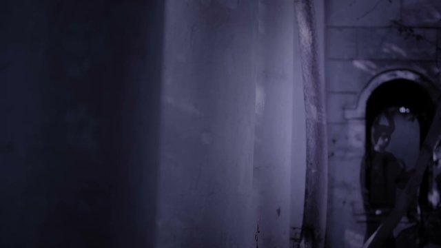 horned witch ghost walks through the ruins of the castle. halloween Horror