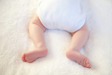 Newborn Baby Legs On The Bed