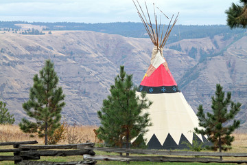 Teepee Behind a Split-Rail Fence Overlooking a Canyon in Oregon © egiadone