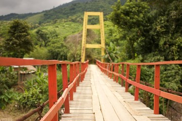 Wooden suspension bridge across the river