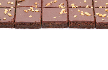 Chocolate Brownies with Nuts on Top on a White Background