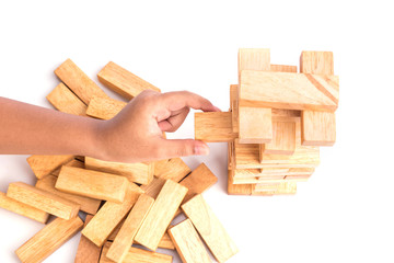 Hand holding blocks wood game (jenga) isolated on white backgrou