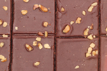 A Background of Chocolate Brownies with Nuts on Top
