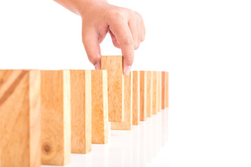 Hand holding blocks wood game (jenga) isolated on white backgrou