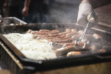 Hausmacher Bratwürste mit Zwiebeln werden gebraten