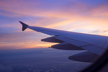 Naklejka na ściany i meble Sunset sky from the airplane window