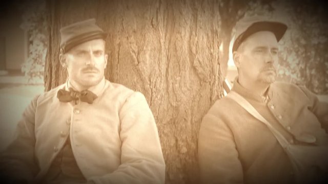 Two tired Civil War soldiers resting by tree (Archive Footage Version)