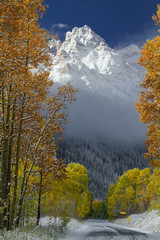Pyramid peak with fall colors, fresh snow and clear sky