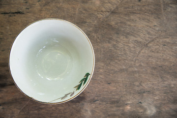 Cup on wood background.