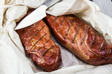 Smoked Pork loin. Homemade smoked pork tenderloins. Smoked meat on the wood crate.