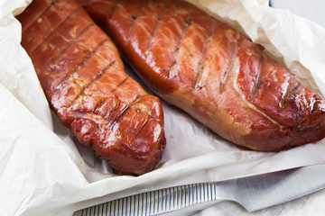 Smoked Pork loin. Homemade smoked pork tenderloins. Smoked meat on the wood crate.