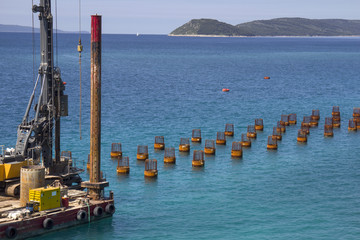 Platform with drilling machine building foundations of new jetty in Split harbor in Croatia
