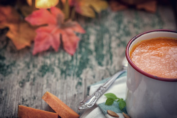 Thanksgiving Pumpkin soup on rustic background with copy space
