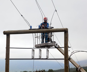 Electrician working at a power transmission line construction