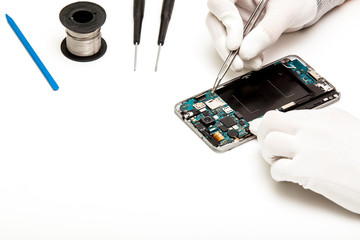 technician repairing broken mobile phone