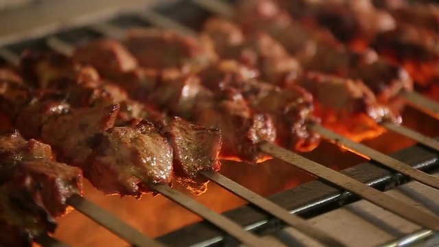 Cook roasts juicy kebab barbecue with crispy grilled slowmotion