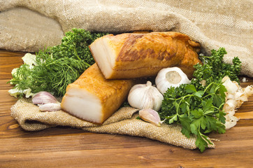 smoked lard  sliced in small pieces on wooden table 