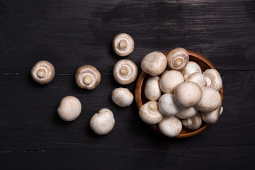 View from above of whole uncooked fresh white button or field mu