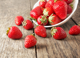 Ripe red strawberries on wooden table